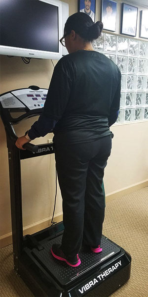 Patient standing on vibe plate